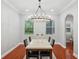 Bright dining room with hardwood floors, modern chandelier, and backyard views at 2011 Water Wheel Ct, Dunedin, FL 34698