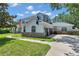 Beautiful home featuring an attached three car garage, well maintained lawn, and stone accents at 2011 Water Wheel Ct, Dunedin, FL 34698