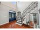 Elegant foyer with soaring ceilings, hardwood floors, and a staircase with iron railings at 2011 Water Wheel Ct, Dunedin, FL 34698
