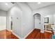 Hallway featuring archways leading to a laundry room and bathroom at 2011 Water Wheel Ct, Dunedin, FL 34698