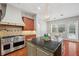 Modern kitchen with stainless steel range and center island featuring granite countertops at 2011 Water Wheel Ct, Dunedin, FL 34698