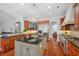 Spacious kitchen featuring custom cabinets, granite countertops and stainless steel refrigerator at 2011 Water Wheel Ct, Dunedin, FL 34698