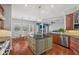 Open concept kitchen with large island, stainless steel appliances, and hardwood floors at 2011 Water Wheel Ct, Dunedin, FL 34698