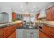 Gourmet kitchen with granite counters, stainless appliances, and center island with sink at 2011 Water Wheel Ct, Dunedin, FL 34698