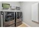 Laundry room featuring front loading washer and dryer and shelf for storage at 2011 Water Wheel Ct, Dunedin, FL 34698