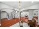 Open-concept living area with hardwood floors, staircase, and view of dining room at 2011 Water Wheel Ct, Dunedin, FL 34698