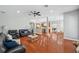 Open living room with hardwood floors leading into the kitchen and dining area at 2011 Water Wheel Ct, Dunedin, FL 34698