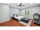 Comfortable primary bedroom with king bed, ceiling fan, and patio access at 2011 Water Wheel Ct, Dunedin, FL 34698
