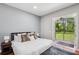 The main bedroom featuring a king bed, bedside tables, and patio access at 2011 Water Wheel Ct, Dunedin, FL 34698