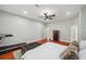 Spacious primary bedroom with a ceiling fan, treadmill, safe, and hardwood floors at 2011 Water Wheel Ct, Dunedin, FL 34698