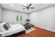 Spacious primary bedroom with a ceiling fan, treadmill, and hardwood floors at 2011 Water Wheel Ct, Dunedin, FL 34698