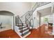 Elegant staircase with wrought iron railing and hardwood floors, leading to the upper level at 2011 Water Wheel Ct, Dunedin, FL 34698
