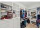 Well-organized walk-in closet with custom shelving, hanging racks, and ample storage space at 2011 Water Wheel Ct, Dunedin, FL 34698