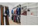 Spacious walk-in closet featuring built-in shelving, hanging rods, and organized storage solutions at 2011 Water Wheel Ct, Dunedin, FL 34698