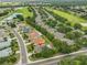 Aerial view of the home and community including a golf course and pond at 2128 Worthington Greens Dr, Sun City Center, FL 33573