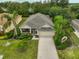 Charming single-story home features lush landscaping, screened porch, two-car garage, and a well-maintained lawn at 2128 Worthington Greens Dr, Sun City Center, FL 33573