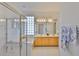 Inviting bathroom with double sinks, glass shower, and decorative touches at 2128 Worthington Greens Dr, Sun City Center, FL 33573