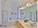 Bright bathroom with double sinks, large tub, and walk-in shower at 2128 Worthington Greens Dr, Sun City Center, FL 33573