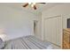 Bedroom with a ceiling fan, double closet, and decorative window at 2128 Worthington Greens Dr, Sun City Center, FL 33573
