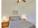 Comfortable bedroom with ceiling fan, and a large bed with coordinated bedding at 2128 Worthington Greens Dr, Sun City Center, FL 33573