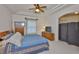 Relaxing bedroom featuring a ceiling fan, large window, and tile floors at 2128 Worthington Greens Dr, Sun City Center, FL 33573