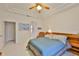 Bright bedroom featuring neutral walls, tile floors, and a cozy armchair at 2128 Worthington Greens Dr, Sun City Center, FL 33573
