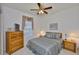 Comfortable bedroom with ceiling fan, and a large bed with coordinated bedding and dresser at 2128 Worthington Greens Dr, Sun City Center, FL 33573