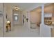 Bright entryway features tile flooring, decorative pillars, and an open view of the living spaces at 2128 Worthington Greens Dr, Sun City Center, FL 33573