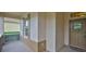 Inviting front entry featuring a beige door, with a screen enclosed porch at 2128 Worthington Greens Dr, Sun City Center, FL 33573