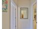 Hallway showing wall mirror with views of another room and an entryway at 2128 Worthington Greens Dr, Sun City Center, FL 33573
