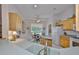 Bright kitchen and breakfast nook area with tile flooring and light wood cabinets at 2128 Worthington Greens Dr, Sun City Center, FL 33573