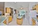 Bright kitchen and breakfast nook area with tile flooring and light wood cabinets at 2128 Worthington Greens Dr, Sun City Center, FL 33573