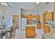 Bright kitchen featuring a center island, wooden cabinets, and white appliances at 2128 Worthington Greens Dr, Sun City Center, FL 33573