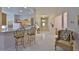 Bright kitchen featuring bar seating and a view of the home's entryway and living space at 2128 Worthington Greens Dr, Sun City Center, FL 33573