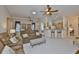 Spacious living area with sofas, tile flooring, and seamless access to dining and kitchen at 2128 Worthington Greens Dr, Sun City Center, FL 33573