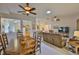 Bright open-concept living and dining area with tiled floors and ceiling fans at 2128 Worthington Greens Dr, Sun City Center, FL 33573