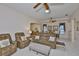 Living area featuring neutral colors, comfortable seating and seamless flow to dining at 2128 Worthington Greens Dr, Sun City Center, FL 33573