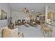 Expansive living room with three ceiling fans, comfortable seating, tile flooring and an open layout at 2128 Worthington Greens Dr, Sun City Center, FL 33573
