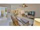 Open-concept living room with tile flooring and a view into the adjacent kitchen at 2128 Worthington Greens Dr, Sun City Center, FL 33573