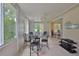Bright sun room with tile flooring, outdoor views, and comfortable seating area at 2128 Worthington Greens Dr, Sun City Center, FL 33573
