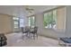 Bright sunroom featuring large windows, tile floors, and a ceiling fan, perfect for relaxation and entertaining at 2128 Worthington Greens Dr, Sun City Center, FL 33573