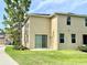 Exterior back of home with a sliding glass door and green grass, showcasing the backyard and a corner lot at 2130 Broadway View Ave, Brandon, FL 33510