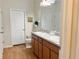 Well-lit bathroom with double sinks, modern fixtures, and a door, offering a blend of functionality and style at 2130 Broadway View Ave, Brandon, FL 33510