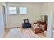 Bedroom filled with belongings, light flooring, and a pair of windows with views of neighborhood homes and foliage at 2130 Broadway View Ave, Brandon, FL 33510