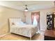 Primary bedroom with hardwood floors, a queen bed, a ceiling fan, a window with curtains and decor shelves at 2130 Broadway View Ave, Brandon, FL 33510