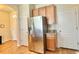 Efficient kitchen space with stainless steel refrigerator, wooden cabinetry, and ample storage, conveniently located near the hallway at 2130 Broadway View Ave, Brandon, FL 33510