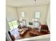 Bright living room and dining area featuring hardwood floors, high ceilings and natural light from windows and sliding glass door at 2130 Broadway View Ave, Brandon, FL 33510