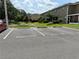 Parking lot with VISITOR labeled parking spots with pond and foliage in the background on a sunny day at 2130 Broadway View Ave, Brandon, FL 33510