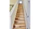 Staircase with modern wood steps and white railing, leading to the upper level of the home at 2130 Broadway View Ave, Brandon, FL 33510