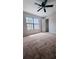 Bedroom with carpeting, large window, and neutral colored walls at 2302 Maki Rd # 69, Plant City, FL 33563